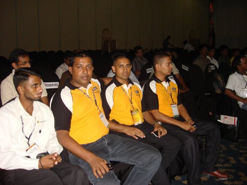 Sri Lanka user group leaders and MVPs Joy, Chandana, Gogula and Dinesh seated together at the event, three in yellow shirts and one in a white shirt